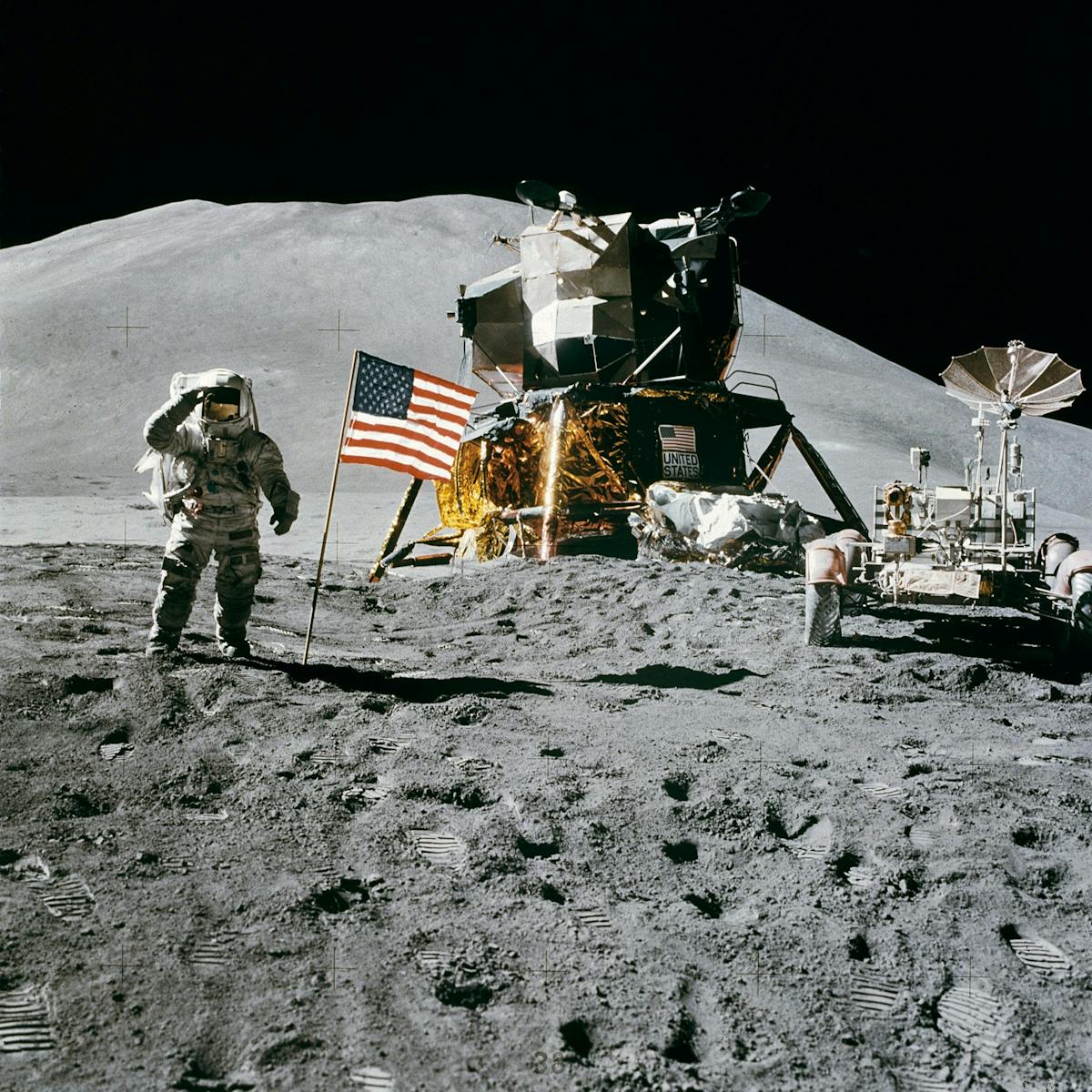 Astronaut on the moon near lunar module and American flag during historic landing.